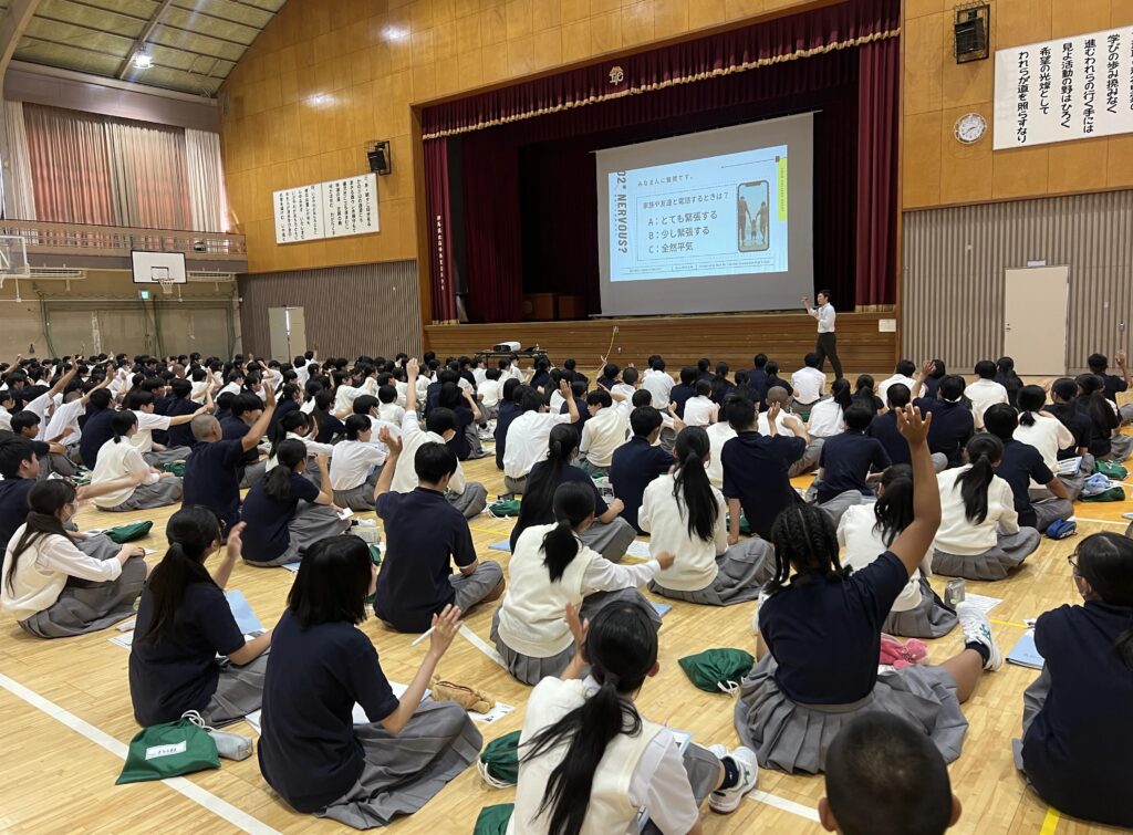 高崎商業高校の生徒が企業への電話対応マナー講演で積極的に手を挙げている様子